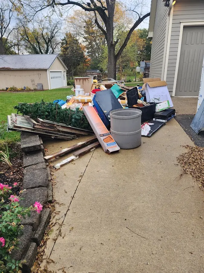 Dumpster being loaded with debris for 12 Yard Dumpster Rental in Westphalia